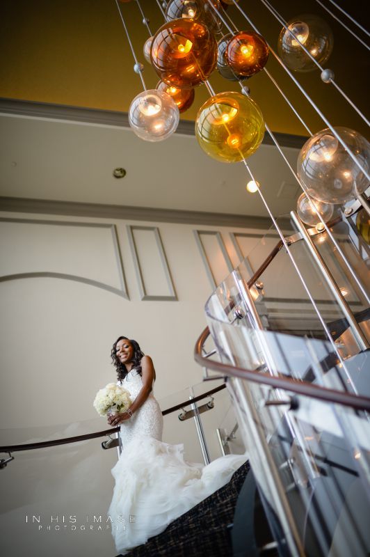Bride standing on staircase at the City Club Raleigh