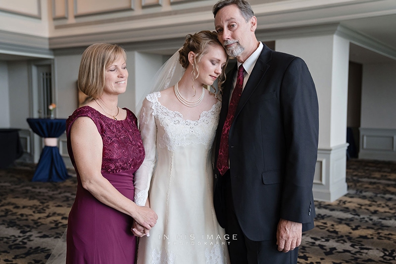 Bride having a tender moment with her parents