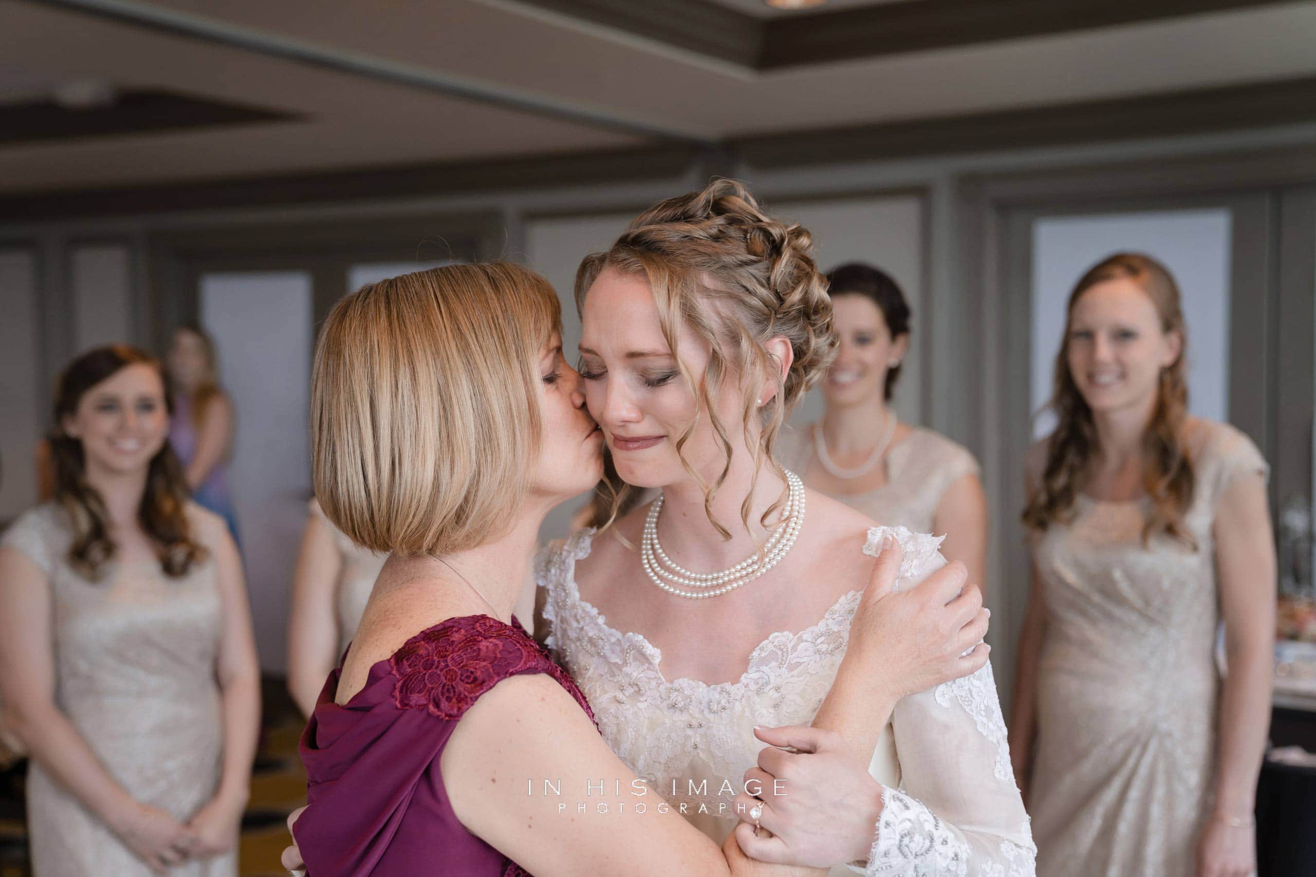 mother-of-the-bride kisses emotional daughter