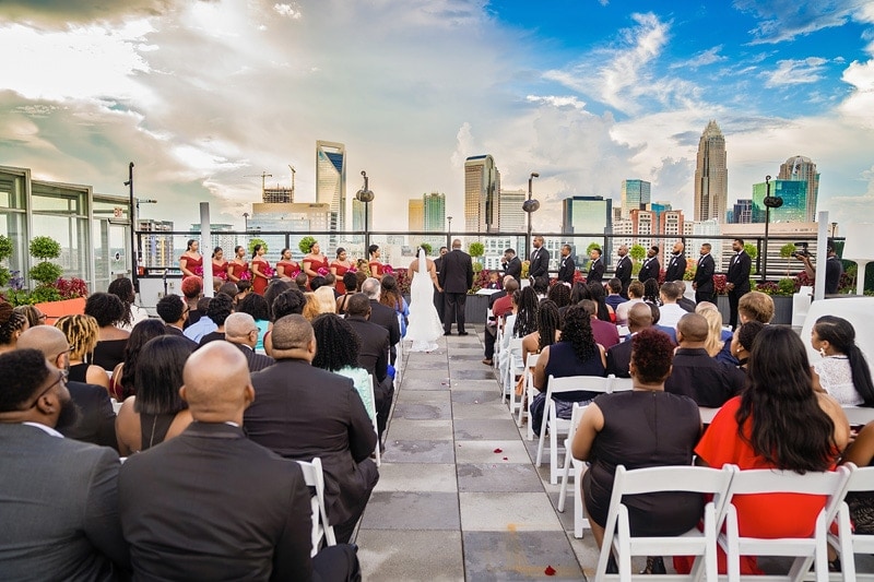 A picturesque rooftop wedding ceremony with stunning cityscape backdrop, captured brilliantly by talented wedding photographers.
