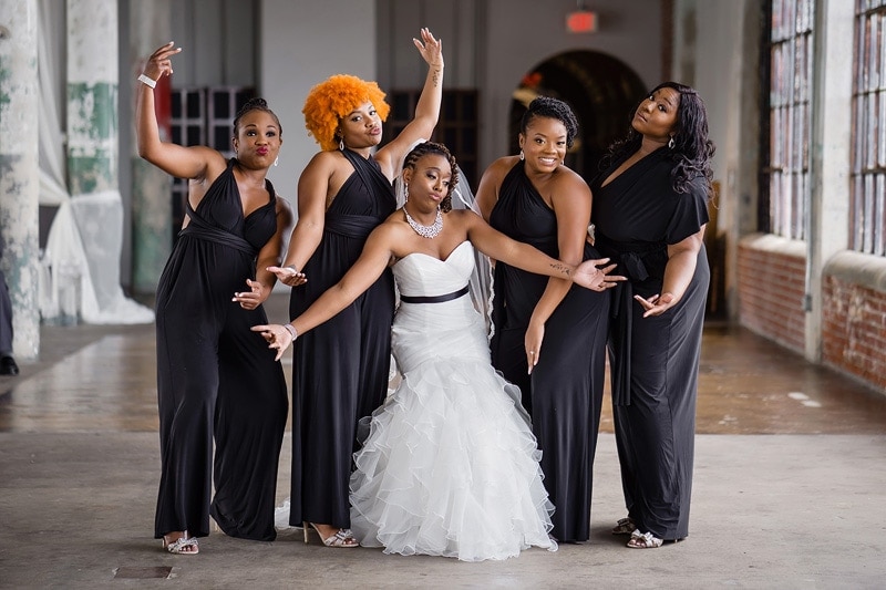 A bride and her bridesmaids pose for a wedding photographers photo.
