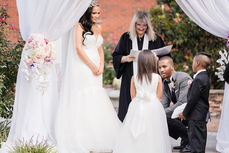 A wedding ceremony with a bride and groom and their children captured on their wedding day.
