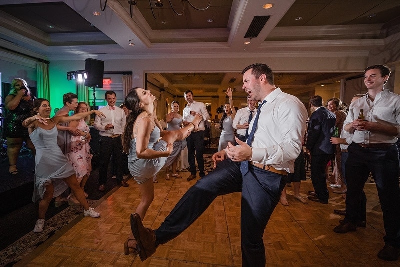 A Wedding Gallery featuring a bridesmaid and groom on the dance floor at a wedding reception.