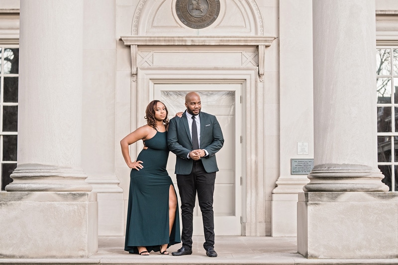 An engagement photographer captures a beautiful moment between a man and woman in front of a building, creating stunning engagement photos.