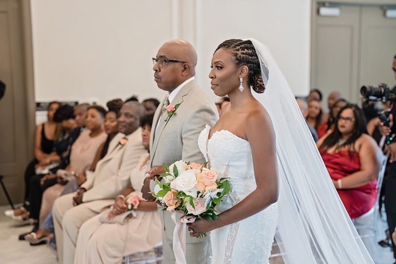 Bride escorted during her wedding entrance at the Crystal Ballroom Charlotte