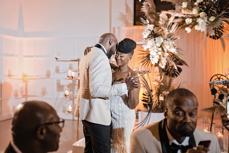 A bride and groom celebrate their love with a kiss at their elegant wedding reception at The Distillery.