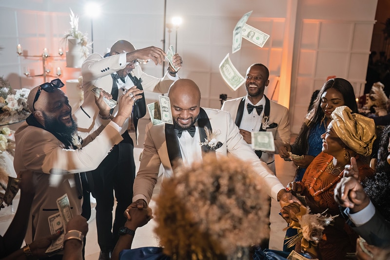 Guests at the Distillery wedding enthusiastically toss money amongst themselves.