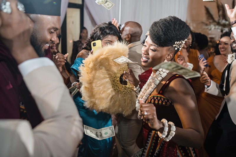 A group of people dancing at an African wedding at the distillery.