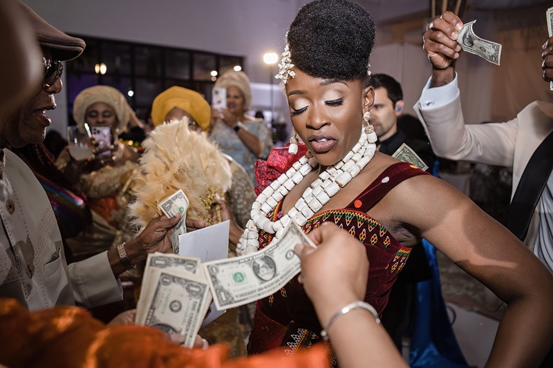 A woman with money in her hands at a distillery wedding party.