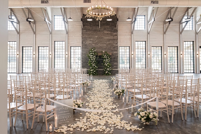 A room adorned with chairs and elegant flowers for Board and Batten Events Wedding.