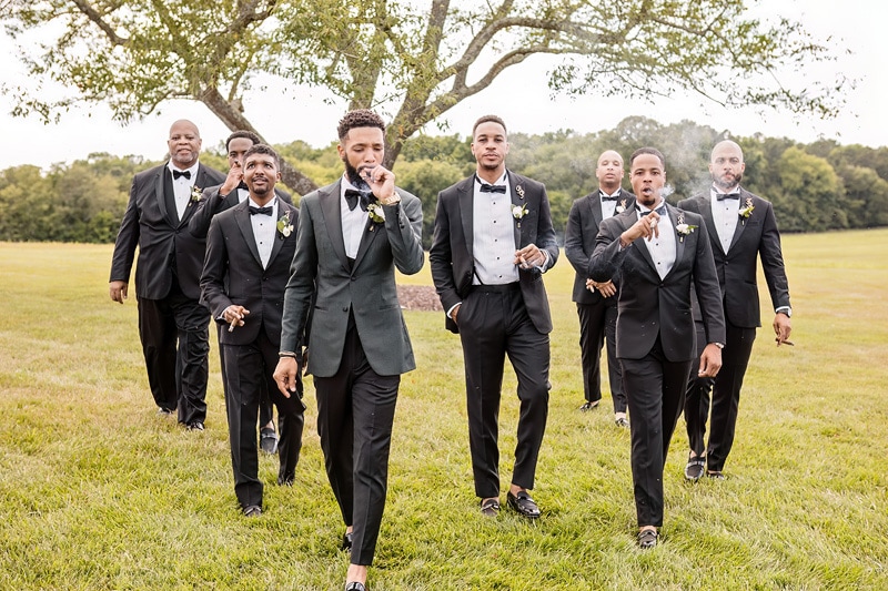 A group of groomsmen in tuxedos at a Board & Batten Wedding.
