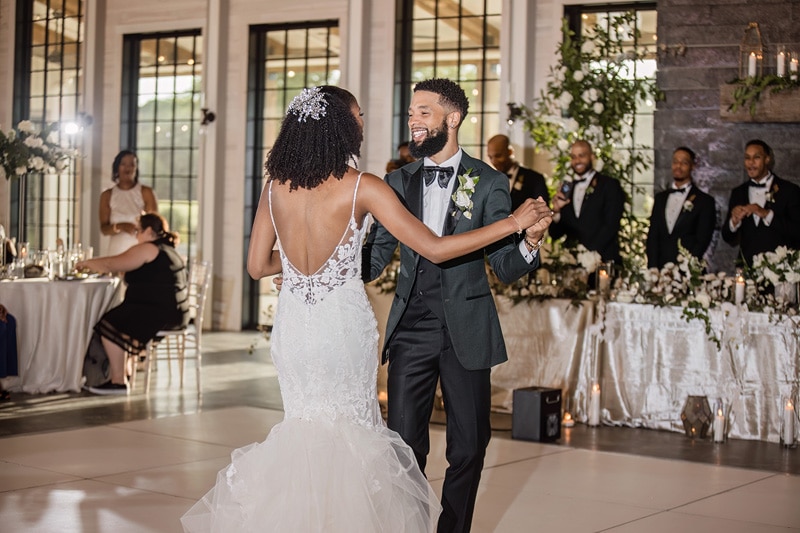 A bride and groom sharing their first dance at a Board & Batten Events wedding reception.