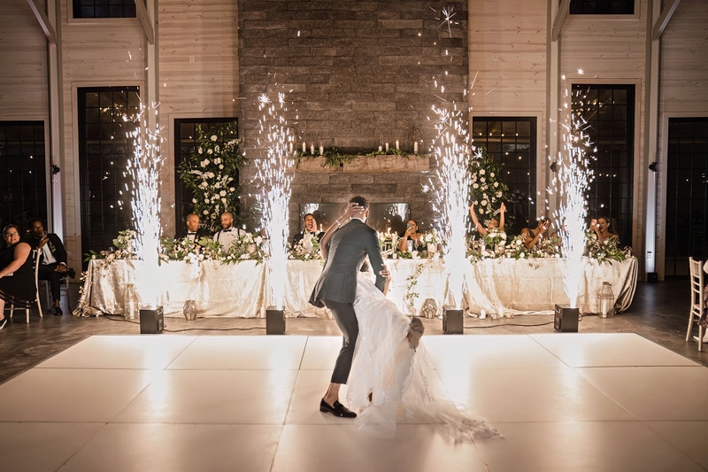 A bride and groom dancing with sparklers at their Board & Batten Events Wedding reception.