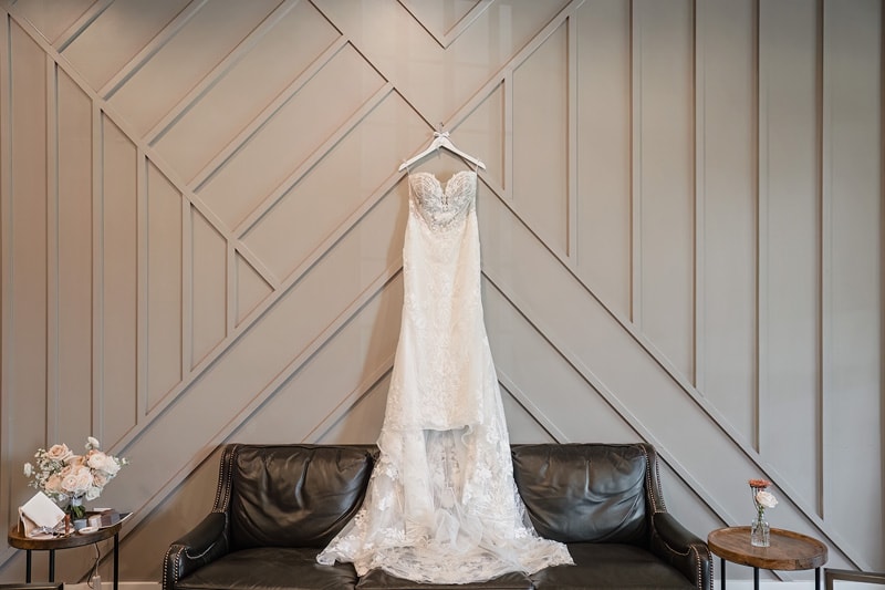 A wedding dress hangs in a room at Board and Batten Events, a wedding venue in Lexington.