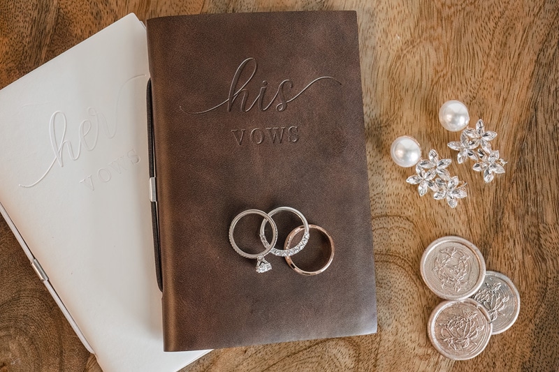 A wedding journal adorned with rings and coins from NC.