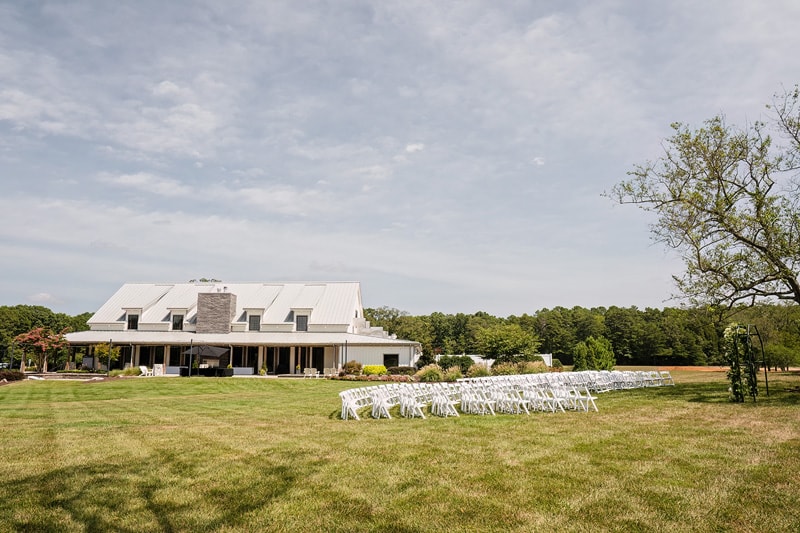 A wedding ceremony set up in front of the Board and Batten Wedding Venue in NC.
