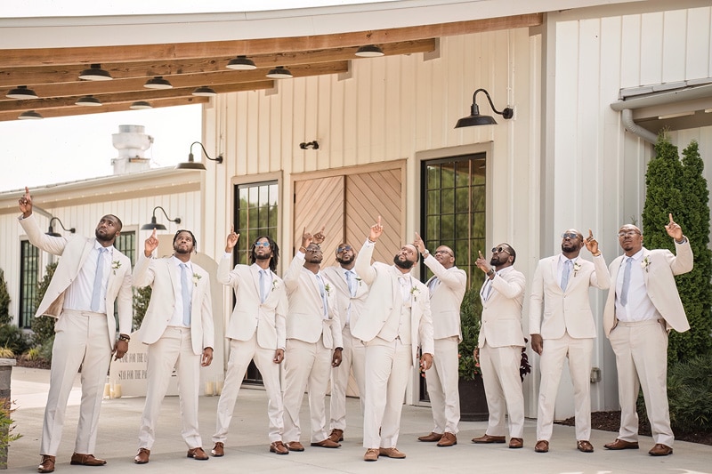 A group of groomsmen in suits at Board & Batten Wedding Venue.