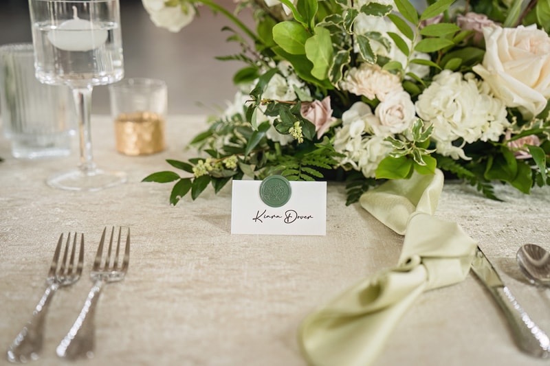 At Board & Batten Events, enjoy a beautifully arranged table setting with a place card and silverware for your special event.