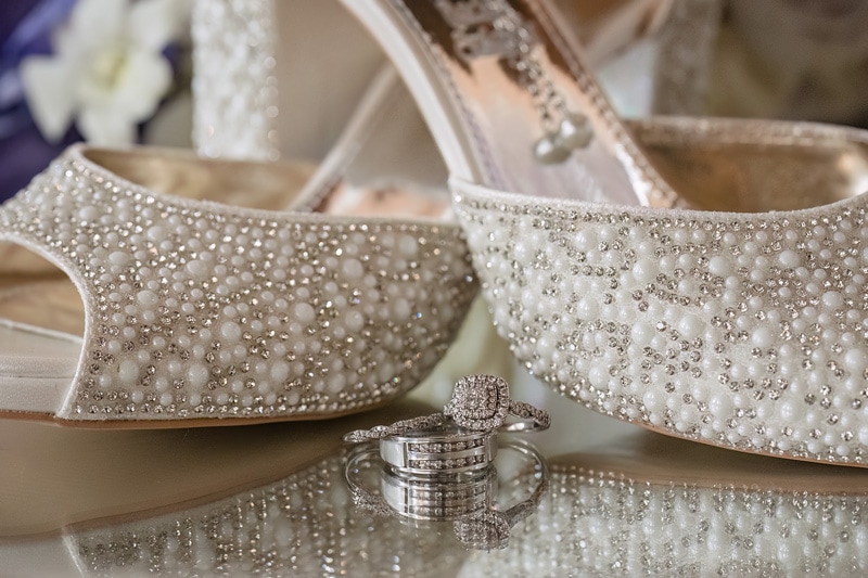 A pair of wedding shoes and a wedding ring for a Pinehill Pavilion Wedding.