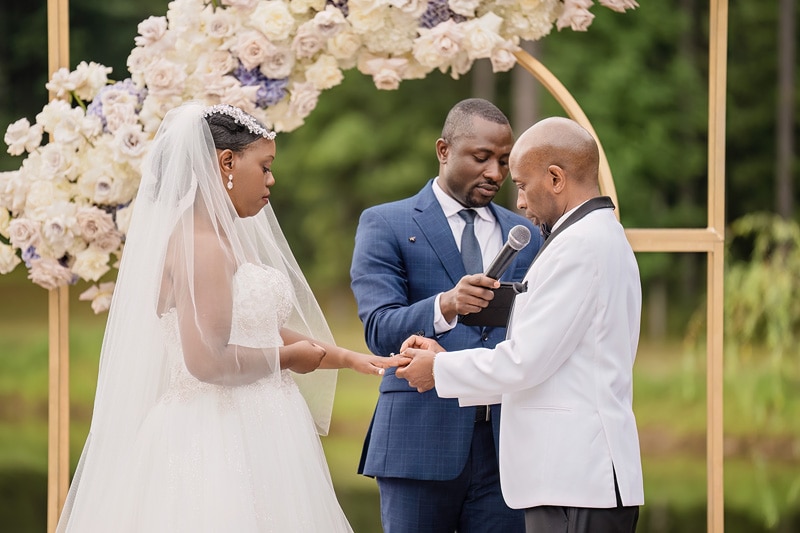 A Pinehill Pavilion wedding unfolds as the bride and groom exchange heartfelt vows surrounded by the breathtaking outdoor scenery.