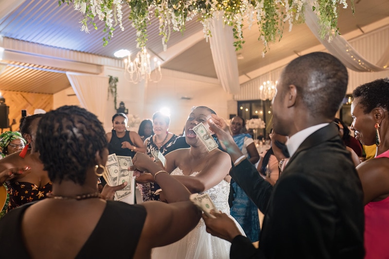 A group of people at a Pinehill Pavilion wedding holding money.