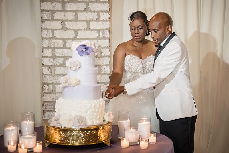 A Pinehill Pavilion Wedding couple cutting a wedding cake.