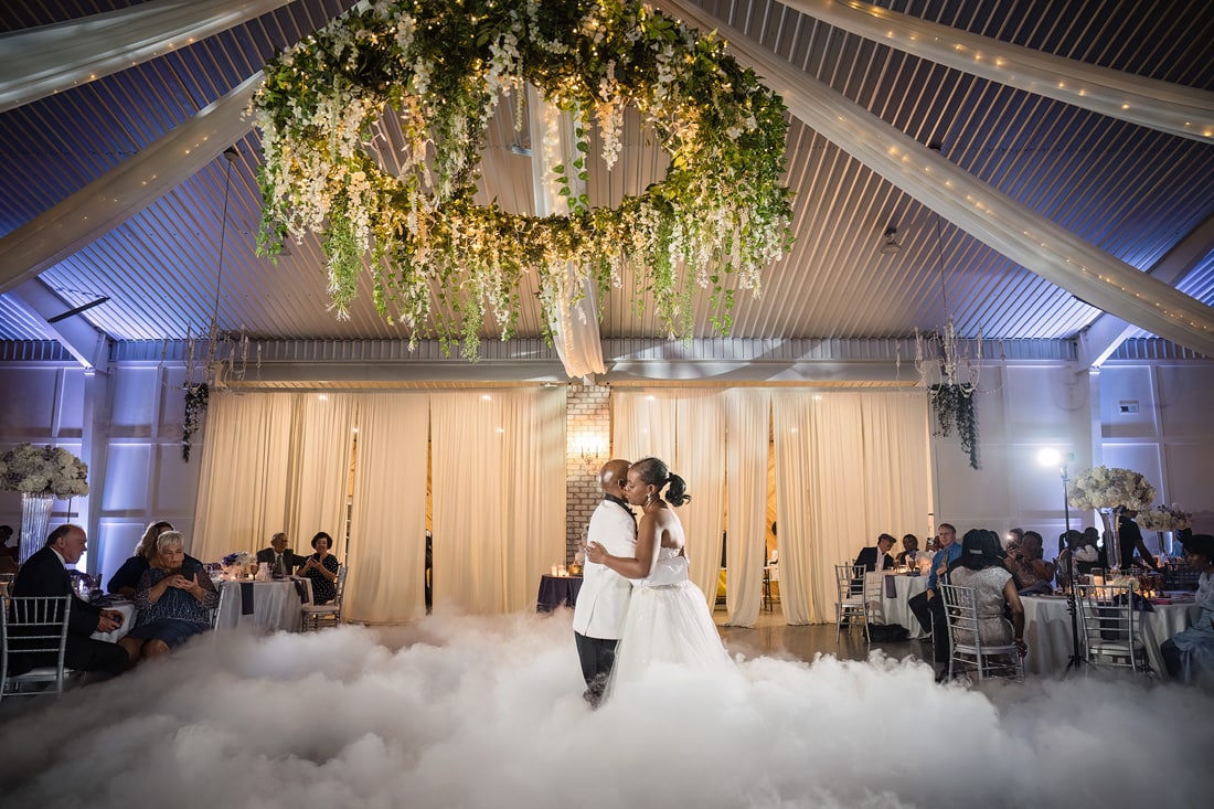 The Pinehill Pavilion Wedding showcasing a mesmerizing moment as the bride and groom gracefully dance in the clouds at their reception.