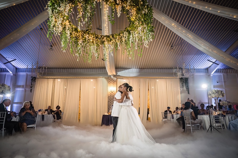 At the enchanting Pinehill Pavilion Wedding venue, a bride and groom gracefully share their first dance under a romantic cloud.