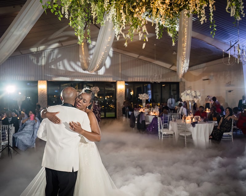 At their Pinehill Pavilion wedding reception, a bride and groom elegantly dance in the clouds.