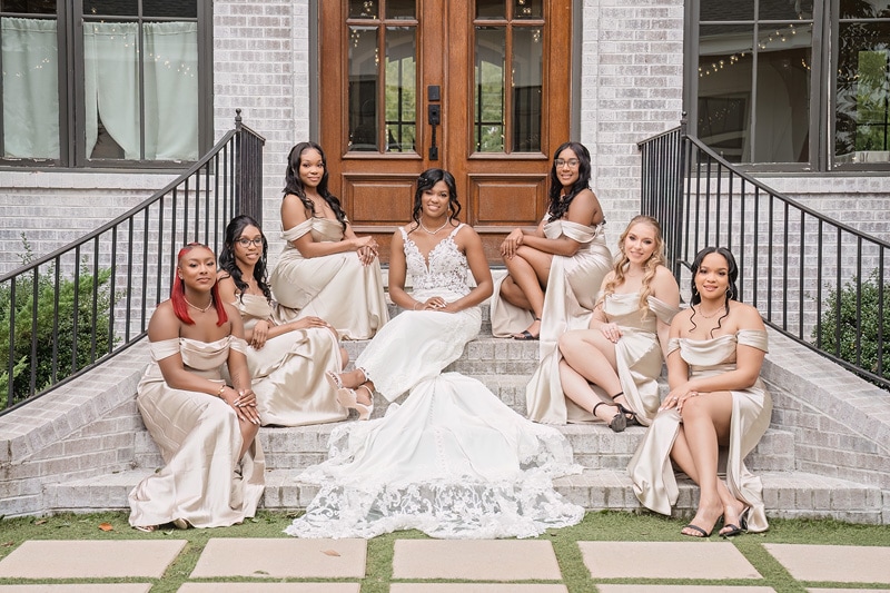 A group of bridesmaids posing on the steps of The Bradford wedding venue.