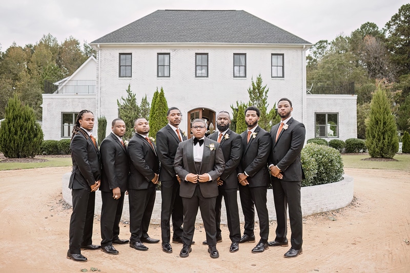 A group of groomsmen posing in front of The Bradford wedding venue.