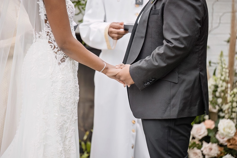 A man and woman standing in front of The Bradford wedding venue, holding hands.