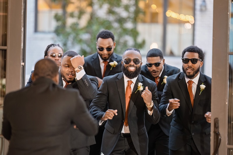 A group of men in suits and sunglasses at The Bradford wedding venue.