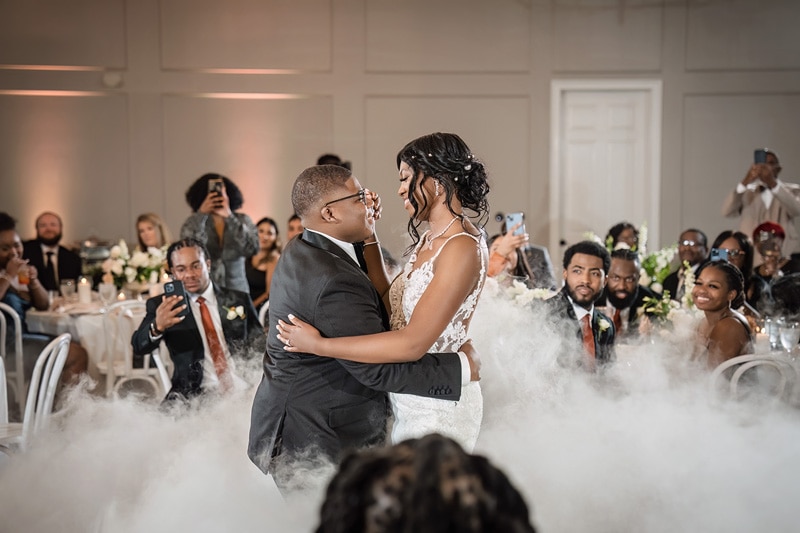 A man and woman dancing at The Bradford wedding venue, surrounded by smoke.