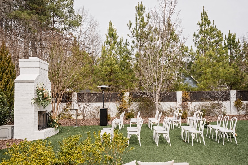 A beautiful outdoor ceremony set up with white chairs at The Bradford wedding venue.