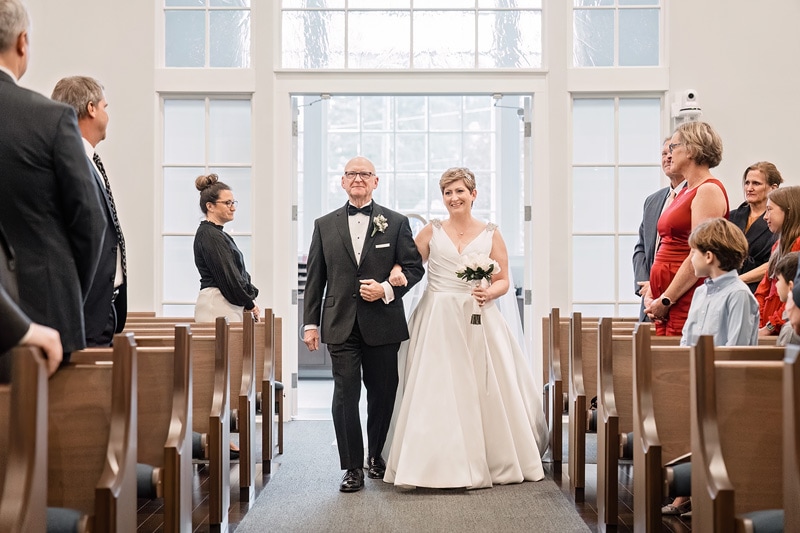Brad and Shana, a lovely couple, are joyfully walking down the aisle of Westminster Presbyterian Church on their wedding day.