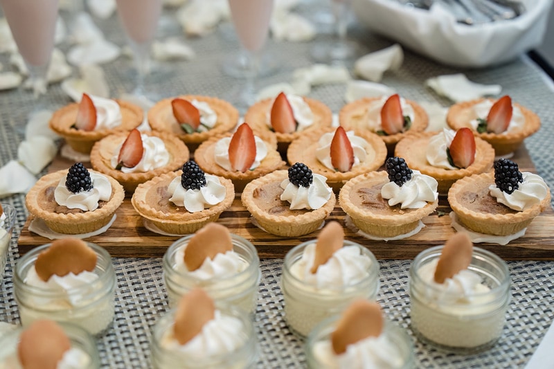 A tray of mini desserts with whipped cream and strawberries, perfect for their redding reception at Grandover Resort & Spa.