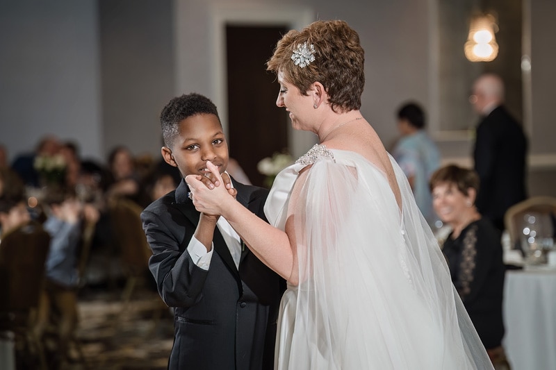 Brad + Shana's young son is dancing with his mother at their Grandover Resort & Spa wedding reception.