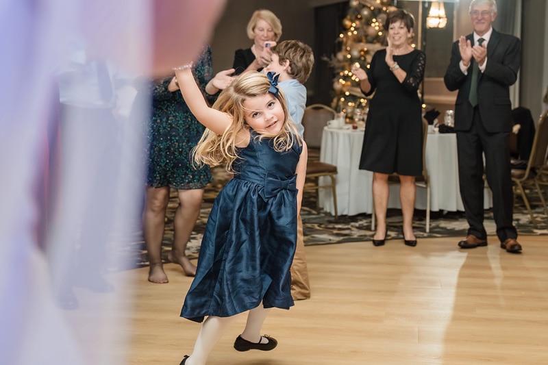 A little girl dancing at a wedding reception at Grandover Resort & Spa with Brad + Shana.