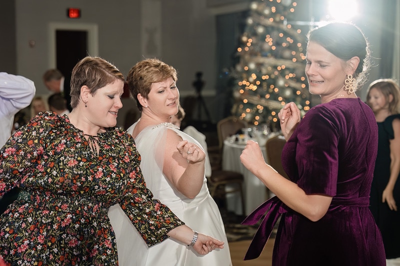 A group of women dancing at Brad and Shana's wedding reception at Grandover Resort & Spa.
