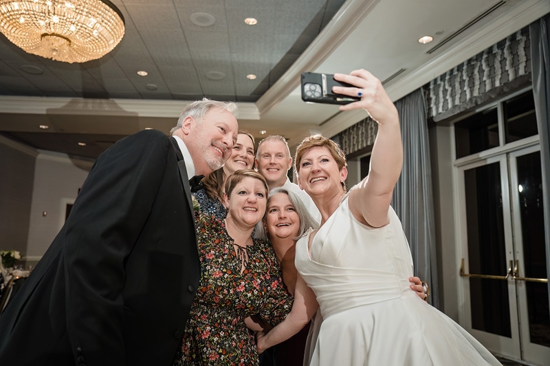 A group of people taking a selfie at a Grandover Resort & Spa wedding reception.