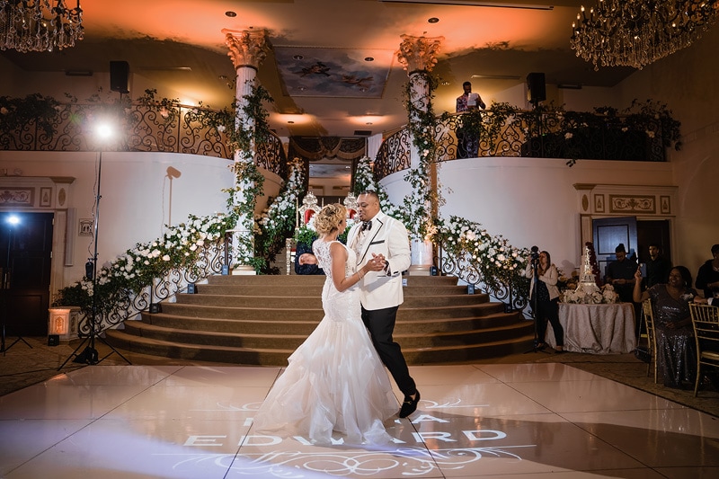 Bride and groom sharing their first dance at a grand marquise ballroom wedding reception.