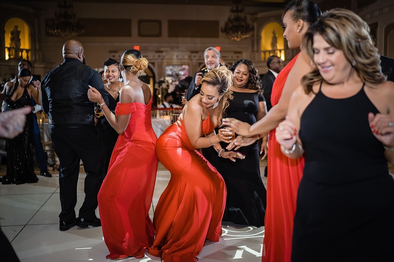 Guests dancing and enjoying themselves at a grand marquise ballroom wedding.