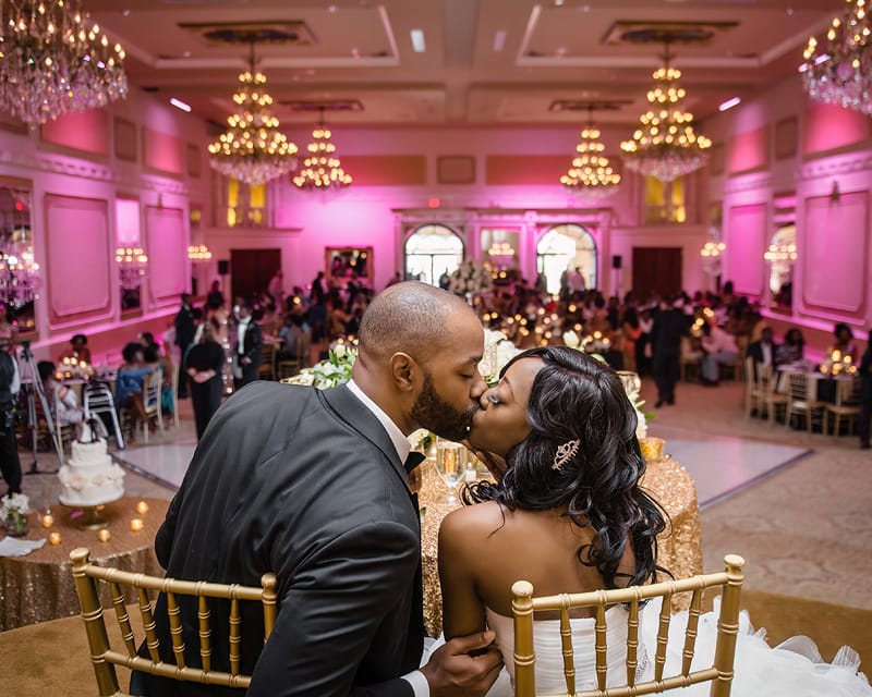 A couple sharing a kiss at their Grand Marquise Ballroom wedding reception.