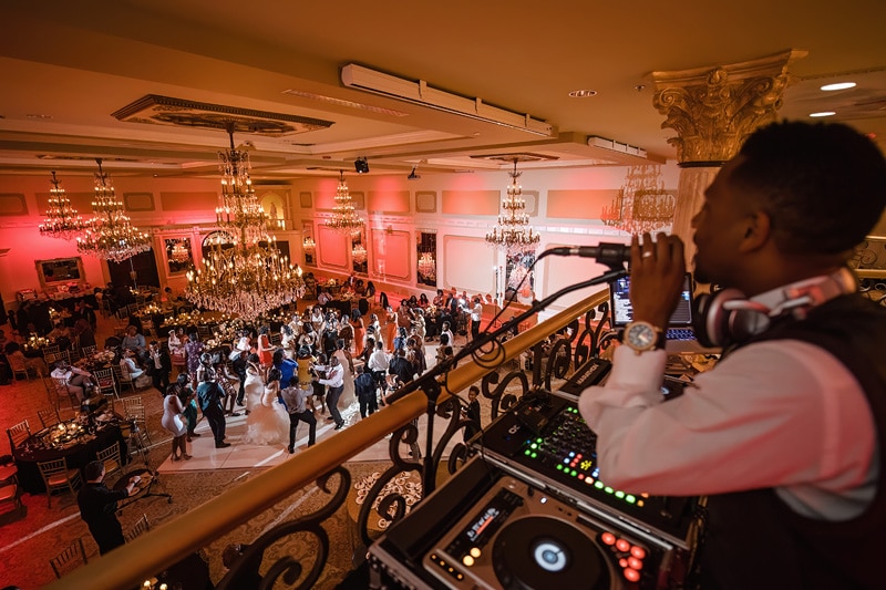 Dj performing at a bustling dance floor during an elegant Grand Marquise Ballroom wedding event.